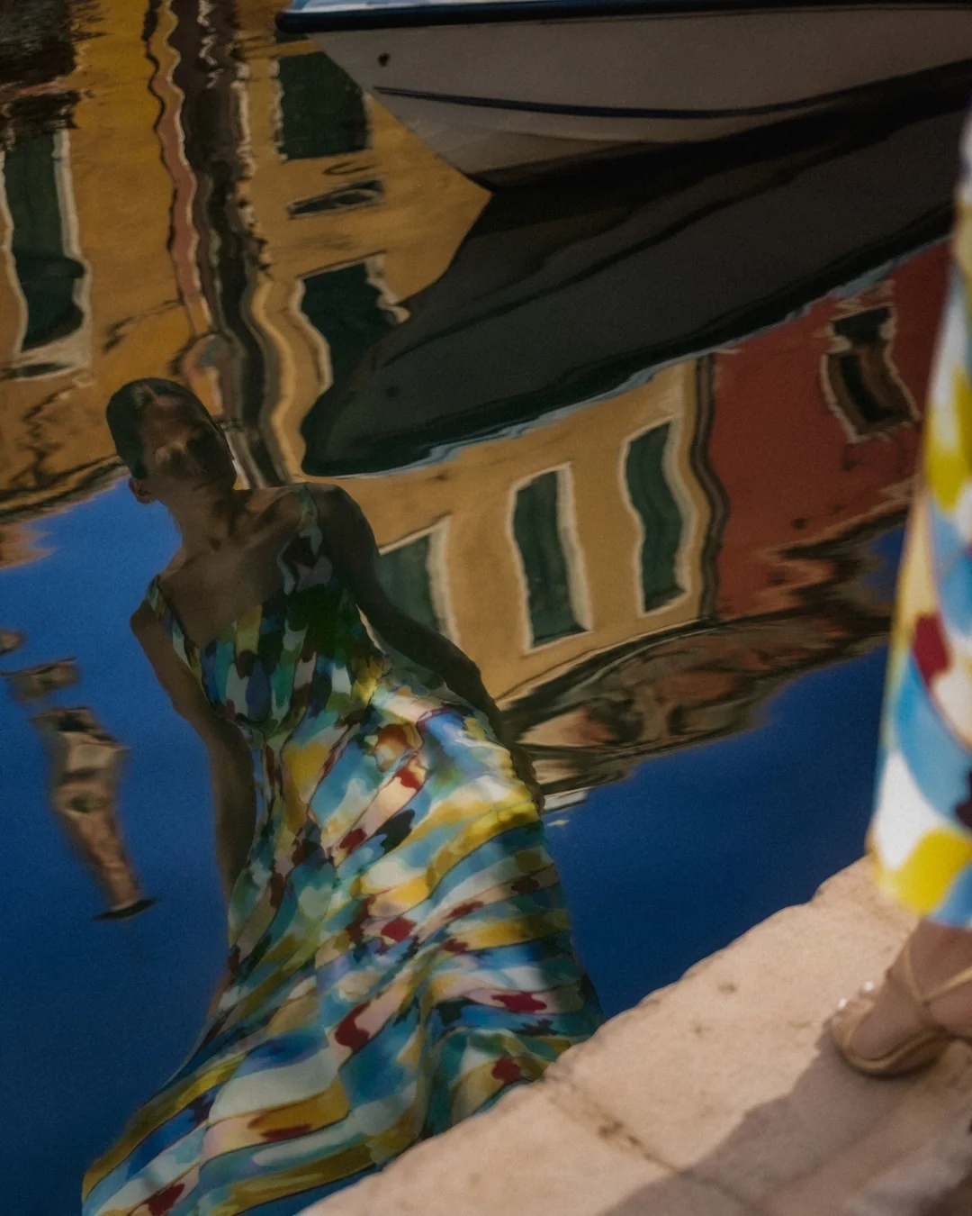 AI fashion campaign visual: Mary Katrantzou dress reflected in canal water